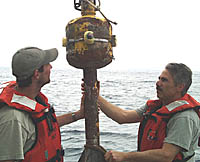 Chief Engineer Ron Wheatley checking one of R/V Melville&rsquo;s main engines.