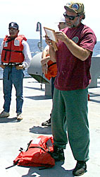 Dave taking roll call during the weekly fire and boat drill wearing his fuzzy hat!