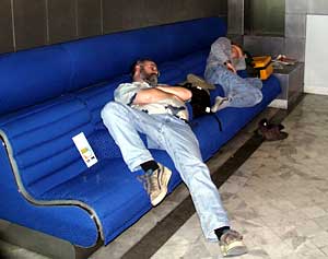 Dan Fornari lowers a hydrophone into the water to listen to and record sounds made by the dolphins and pilot whales.