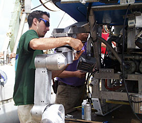 DSOG team member Fran Taylor makes adjustments to Jason’s manipulator, which functions like a giant robotic arm. Scientists control the arm from the ship, manipulating it to collect samples or place equipment on the seafloor.  