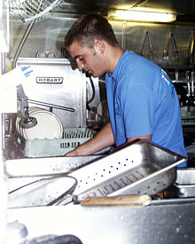 Mess attendant Geryk Paige tackles a mound of dishes after a pork roast and shrimp dinner enjoyed by 58 hungry scientists and crew members. “Geryk has probably the most important job on the ship,” said Steward Mirth Miller.  