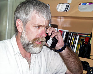 Communications and Electronics Technician Tim Logan talks by phone with other crew members about the status of the ship’s radar, communications and satellite system. 