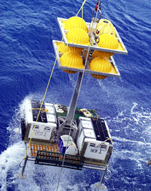 The elevator, filled with samples and equipment, swings precariously as it is lifted out the water.  