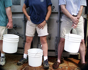 Buckets poised, scientists wait for the hydrothermal vent samples to arrive on deck.  