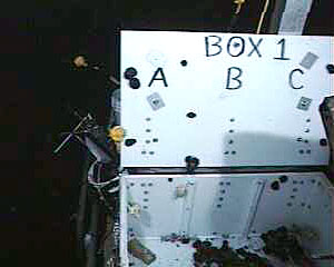 A video camera on ROV Jason filmed the snails we collected attempting an escape from a box on the elevator. The snails are the black spots next to the letter “A.” 