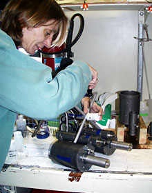 Chemist Karen Von Damm prepares a pair of hydrothermal fluid sampling bottles to go on ROV Jason for its next trip to the seafloor. She is screwing on the white ICL T-Probe coil on the handle of the bottle.  