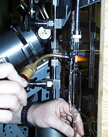 Researcher Eric Olson seals a gas sample taken from a hydrothermal vent in a glass ampoule. He and Chemist Marv Lilley will take the samples back to their lab at the University of Washington for analysis.  