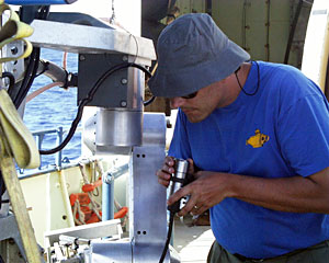 Expedition Leader Andy Bowen inspects the lens of one of Jason’s video cameras.  