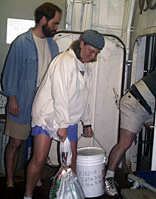  Shana Goffredi, Rob Kunzig and Tim Shank unload dredged rocks from the elevator to be stored in the ship’s hold.  
