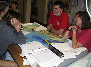 Karen Von Damm (left) confers with Marvin Lilley and Susan Humphris after hearing the good news of finding a hydrothermal plume near 24&deg;S  
