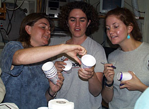 Shana Goffredi, Rachel Gallant and Zoe McKinness admire their Styrofoam cup art work. These cups will head down for a pressure “shrinking” on the next CTD cast then return home in suitcases as souvenirs for friends and families.  