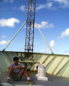 Taking advantage of the calmer seas, DSOG team member Mark Bokenfohr takes an after-lunch break on Knorr’s bow.  