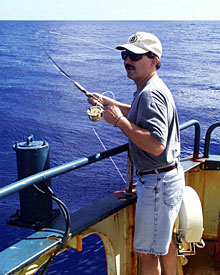Captain AD Colburn tries his luck with a fly rod on the visiting mahi-mahi. The fish took a look at his lure but eventually swam away.  