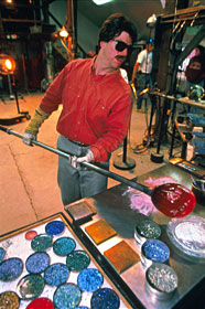Josh selects the next layer of colored glass to make the continents in the Planet. There are many concentric glass layers in a Planet. Each is unique in its depth and color.  