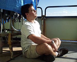 ROV Jason pilot Mark Bokenfohr leans on the CTD as he soaks up the afternoon sun. 