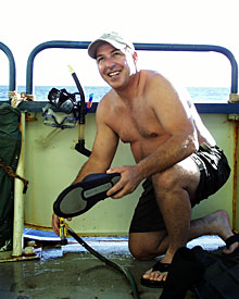 Seaman Jim McGill rinses the salt water from his gear after a swim to retrieve the elevator. 