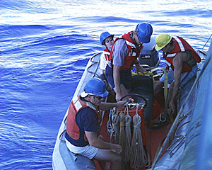 In the workboat for one of the last elevator retrievals of the expedition are Seaman Jim McGill (sitting in bow), Chief Mate Kent Sheasley, DSOG tech Fran Taylor (in yellow hat) and Science Writer Amy Nevala (in sunglasses).  