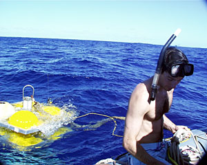 DSOG tech Fran Taylor prepares a line to tie on the elevator. He wears the mask and snorkel so he can see underwater when making line adjustments.  