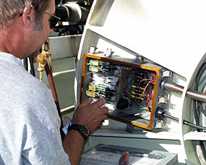 DSOG Engineer Robert “Yogi” Elder checks the slip-rings on the fiber optic winch. The slip-rings transfer the signal from the cable that is wound on the winch drum to the wire the brings the data into the Control Van. 