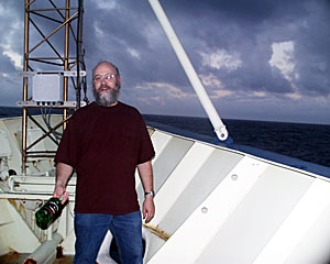 Chemist Bob Collier tosses a bottle of port into the Indian Ocean after a toast to the late MIT Geochemist John Edmond, for whom the Edmond Vent Field is named.  