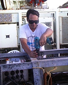 Expedition Leader Andy Bowen helps to dismantle one of the deep submergence vehicles.  