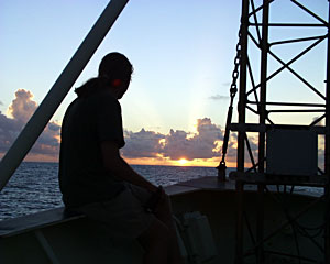 Graduate Student Robbie Young watches our last sunset at sea.  