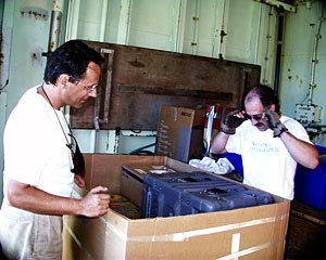 Expedition Leader Andy Bowen and DSOG Team Member Craig Elder prepare a box of equipment that will be sent by air freight back to Woods Hole Oceanographic Institution. 