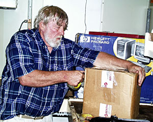 DSOG Team Member Tom Crook readies a box of computer equipment for the trip home.  