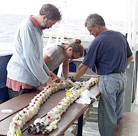 Alberto Saal, Lorna Allison and Tim Hill repair a mooring line by "long splicing." They unraveled the line, cut out the damaged part, and then joined the two pieces by weaving them together to make one line again. Knots and splicing are age-old crafts of the sailor.  