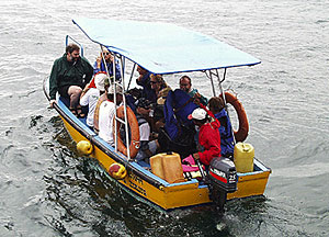 Members of the science party hop on a panga to go ashore in Puerto Ayora.  