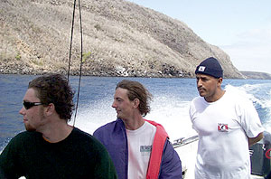 Jeremy Haney, Ben Grosser and Macaron, our dive master for the boat trip, watch Santa F&eacute; Bay draw closer.  
