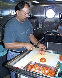  Stacey Lamp, Cook, chops tomatoes in preparation for today's pizza lunch. 
