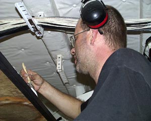  Tim McDaniel, Oiler, paints a shelf in the machine shop. Maintenance on the ship is essential to keeping track of equipment so the right tools are ready at hand. 