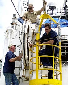  Ron Wheatley, Steve St. Martin, and Dennis Barclay (clockwise), Revelle engineers, have been hard at work all day repairing the winch tensiometer, so that we can resume dredging.  