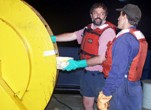  Alberto Saal oils the MR1 sonar fish cable as it is reeled in early this morning. Because we will probably not redeploy the MR1 sonar fish, the cable must be greased so that it does not rust. This will help to ensure that it is in good shape the next time it is used. 