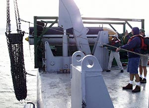  Joe Licciardi (background) and Gene Pillard, Res. Technician recover the rock dredge this morning. 