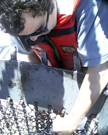  Josh Curtice attaches a new net bag to the dredge. After being used for 27 dredges the net was worn out.  