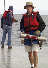  Ben Grosser removes the pinger from the wire as Gene Pillard directs the winch. 