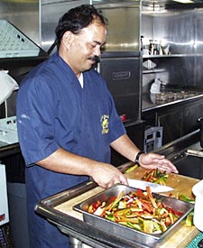  Stacey Lamp, Cook, chops peppers as he prepares today’s meal. 