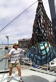 Billy Wells, Wiper, and Lorna Allison, Ordinary Seaman, (driving the crane) move trash while Vic Barnhart, Bosun, directs the operation. 