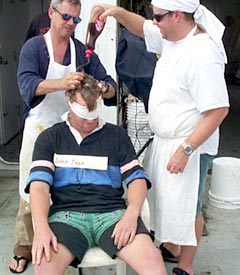 First stop the hair treatment, strawberry syrup and eggs! Bam Bam (Rob Otto) sits in the hair dressers chair. 