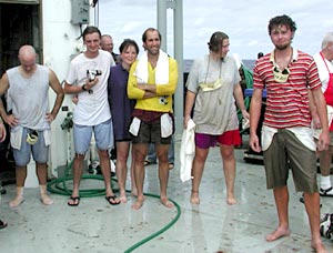The newly initiated Shellbacks watch the remaining Pollywogs go through the ceremony. 