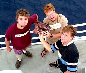 Party Boy (Jeremy Haney - Left), Big Red Petro (Dennis Geist) and Bam Bam (Rob Otto) measure the ship with a squid. 
