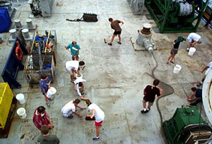 After measuring the ship with various tools (squid, mahi mahi fish and an open can of spam) the Pollywogs were made to scrub down the fan tail. 
