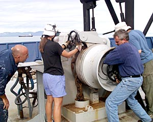 Victor Barnhart (left), the Bosun, oversees dropping the anchor as the crew tend to the anchor windlass. 