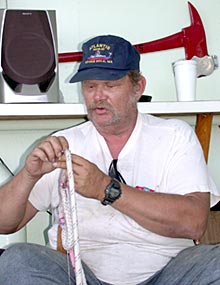  Bosun Wayne Bailey takes time while the submersible is down to splice an eye (or loop) in a piece of braided line. 