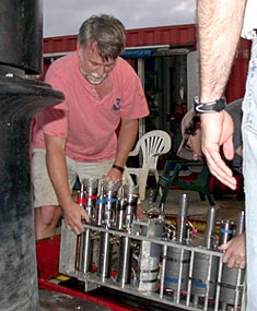 Eric Olson moves the manifold that contains the water sampling bottles from the Alvin and back into the lab so that the fluids can be extracted and analyzed.