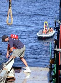 The zodiac waits to collect two swimmers who check that everything is OK on Alvin while it is still at the surface before it dives.