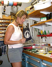  Work is never done aboard ship. Shipboard Technician Christina Courcier takes care of a few minor repairs in the shop aboard ship.