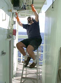  Chipping and painting is a never-ending process on board a ship. Able-Bodied Seaman Jerry Graham spent the afternoon painting on deck.